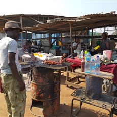 Between Panguila and Barra do Dande, barbecued pork